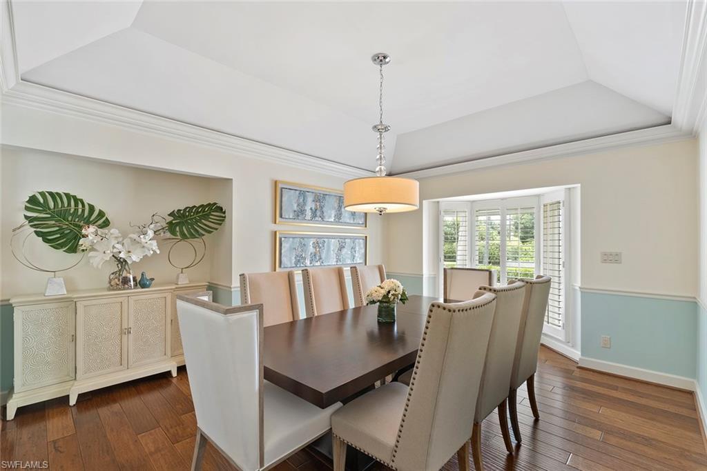 2700 Treasure Lane Naples, FL 34102 - Photo 18 of 44 a view of a dining room with furniture window and wooden floor