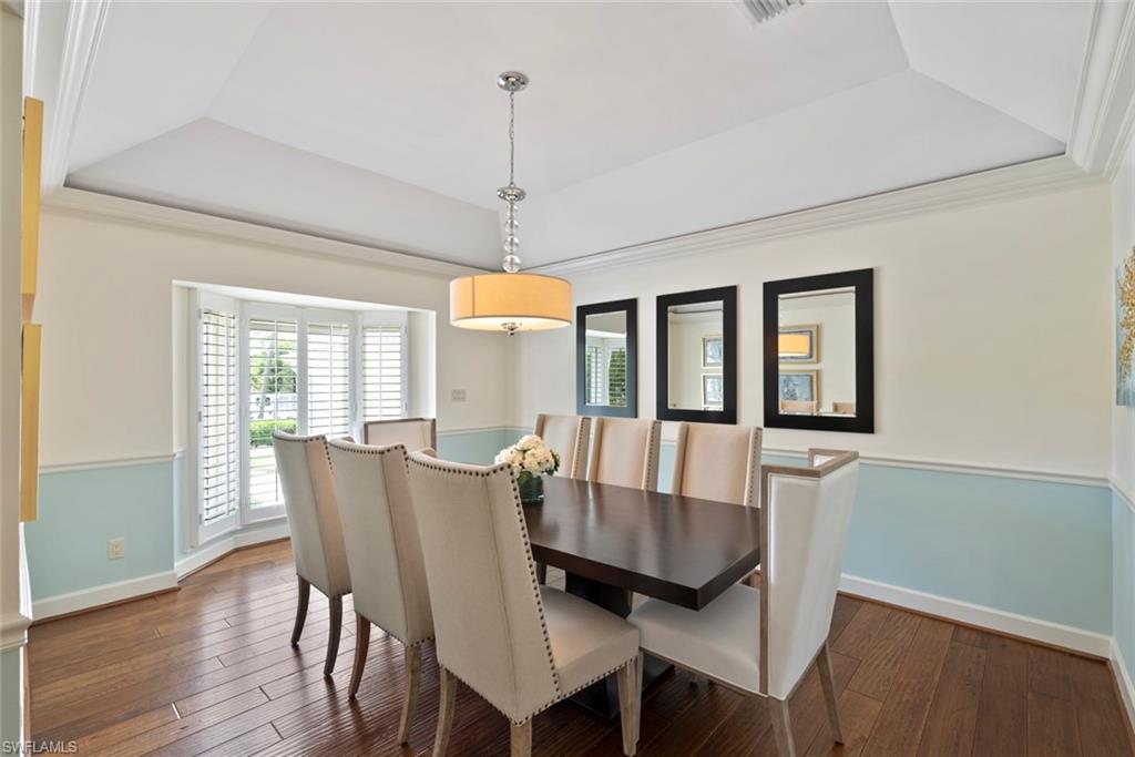 2700 Treasure Lane Naples, FL 34102 - Photo 19 of 44 a view of a dining room with furniture window and wooden floor