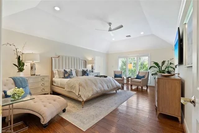 a bedroom with furniture and a large window