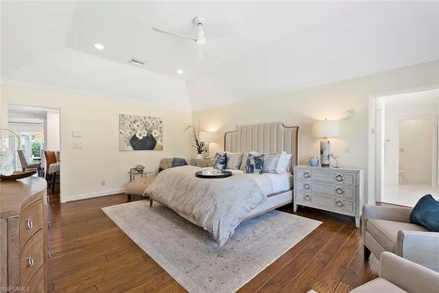 a spacious bedroom with a bed and a couch