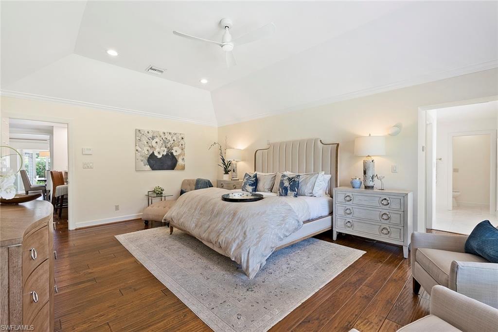 2700 Treasure Lane Naples, FL 34102 - Photo 21 of 44 a spacious bedroom with a bed and a couch