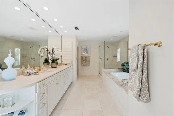a bathroom with a double vanity sink mirror and shower