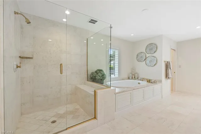a bathroom with a bathtub shower sink mirror and toilet