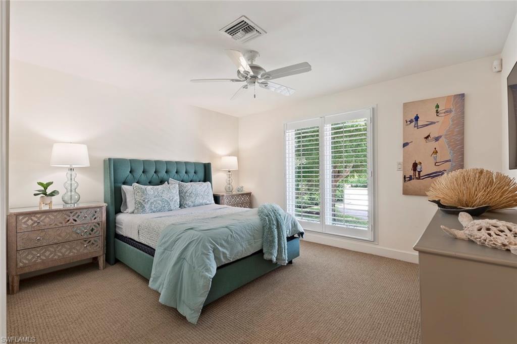 2700 Treasure Lane Naples, FL 34102 - Photo 24 of 44 a bedroom with a bed and a window