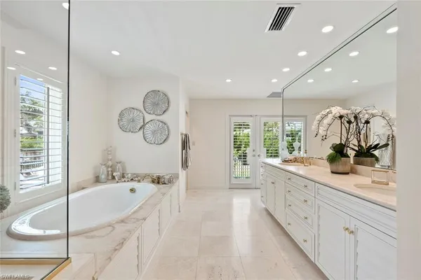 a large bathroom with a large tub and sink