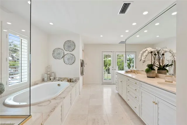 a large bathroom with a large tub and sink