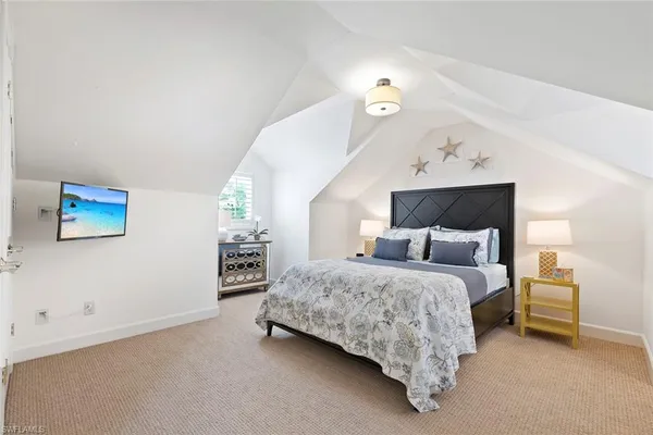 a bedroom with a bed and a lamp on table