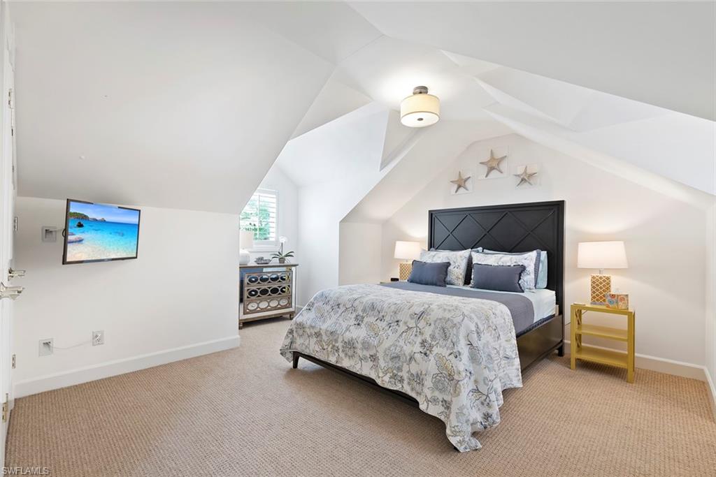 2700 Treasure Lane Naples, FL 34102 - Photo 28 of 44 a bedroom with a bed and a lamp on table