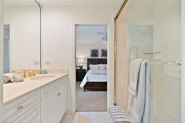 a en suite bathroom with a double vanity sink and a mirror