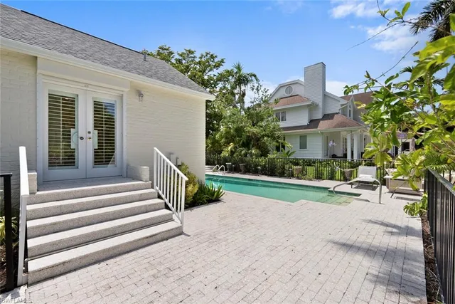 a view of a house with a yard and sitting area