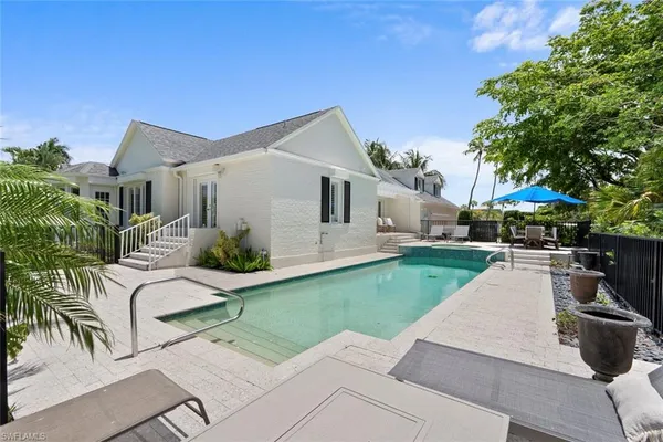 a view of a house with backyard sitting area and garden
