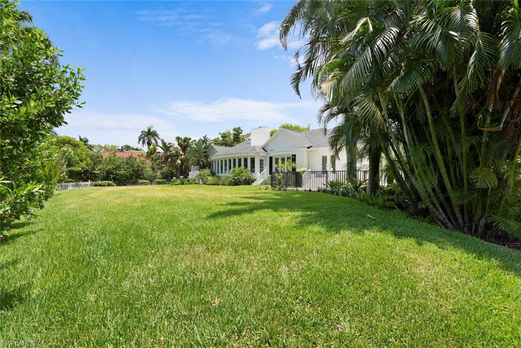 2700 Treasure Lane Naples, FL 34102 - Photo 40 of 44 a view of a garden with a building in the background