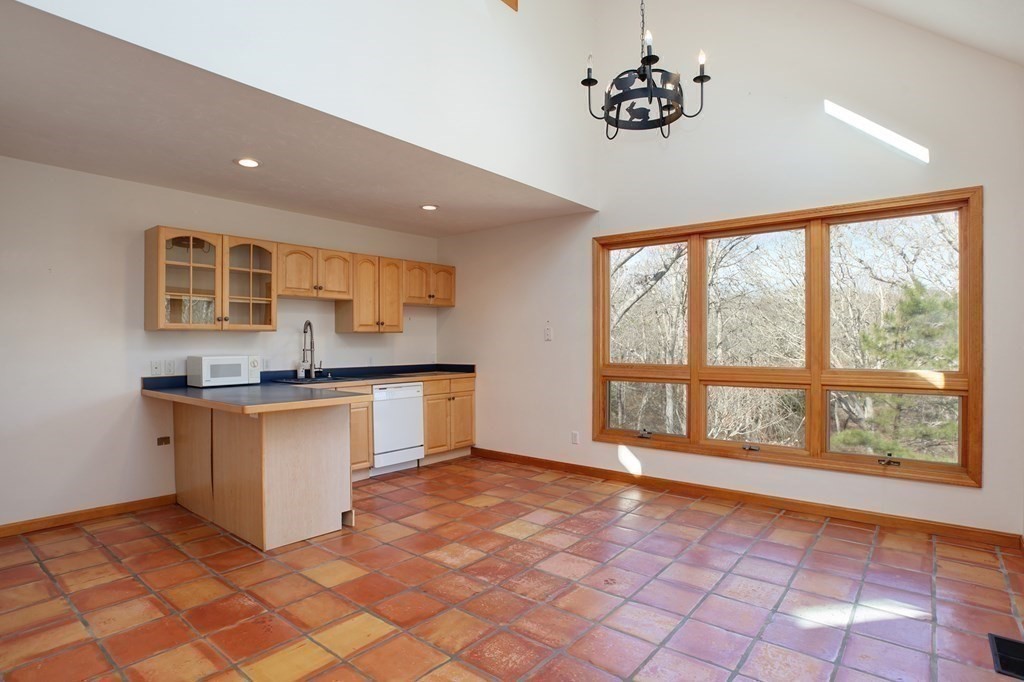 20 Damon Road Falmouth, MA 02540 - Photo 24 of 42 a kitchen with stainless steel appliances granite countertop a stove a sink and a refrigerator