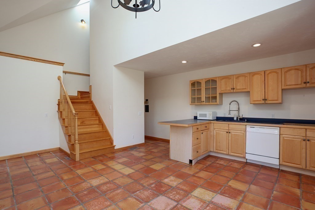 20 Damon Road Falmouth, MA 02540 - Photo 26 of 42 a kitchen with granite countertop a sink and white cabinets