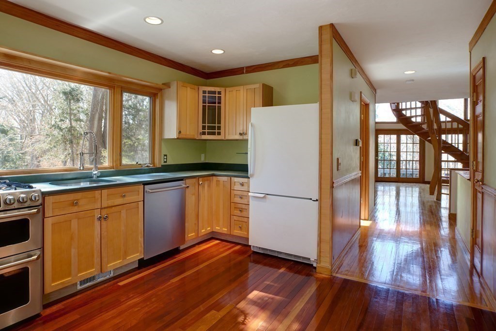 20 Damon Road Falmouth, MA 02540 - Photo 8 of 42 a kitchen with granite countertop wooden floors a stove and white stainless steel appliances