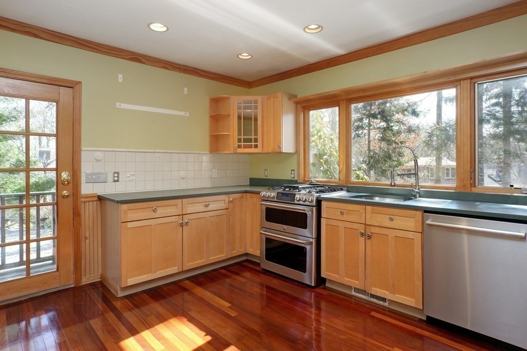 20 Damon Road Falmouth, MA 02540 - Photo 9 of 42 a kitchen with granite countertop wooden floors and white appliances