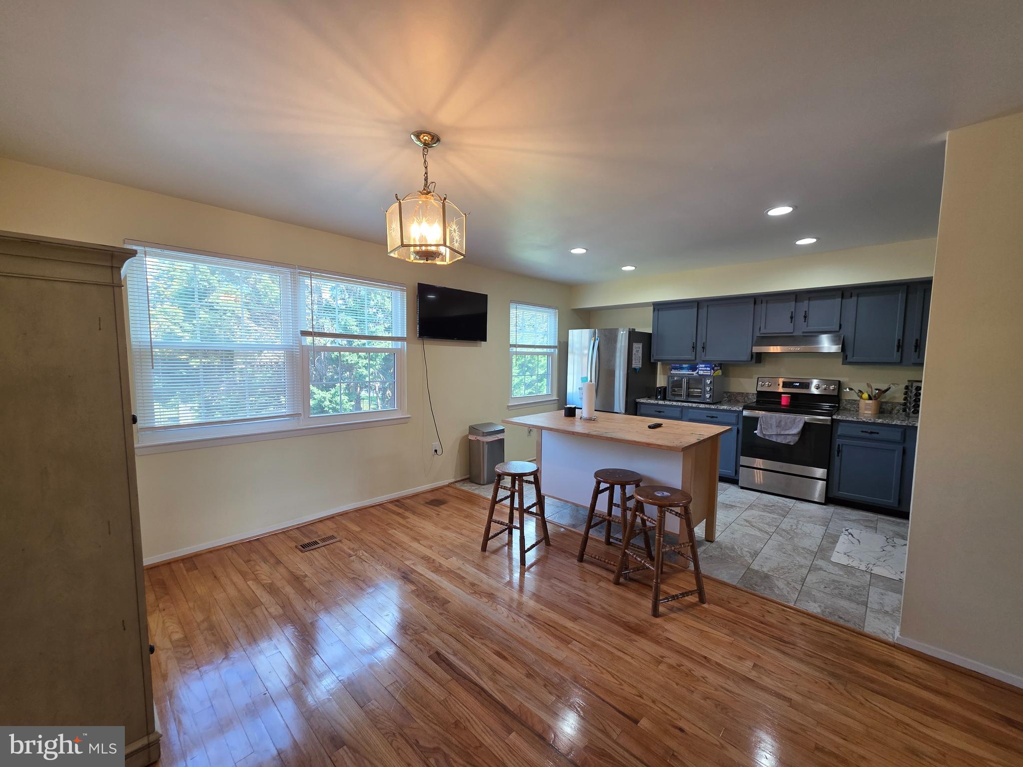 10 Casey Court Baltimore, MD 21228 - Photo 17 of 28 a open kitchen with dining table and wooden floor