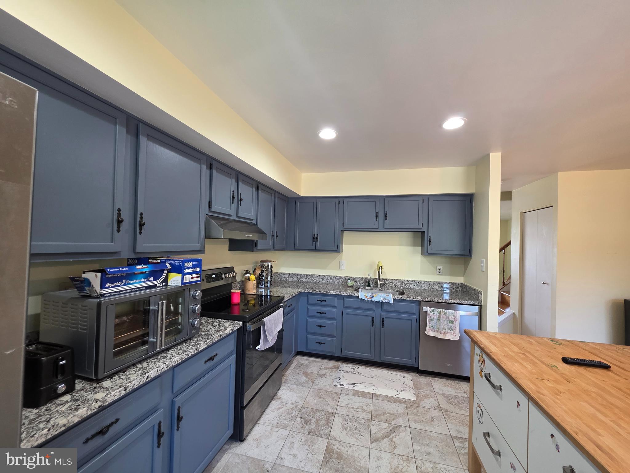10 Casey Court Baltimore, MD 21228 - Photo 20 of 28 a kitchen with stainless steel appliances granite countertop wooden cabinets a stove a sink and a oven