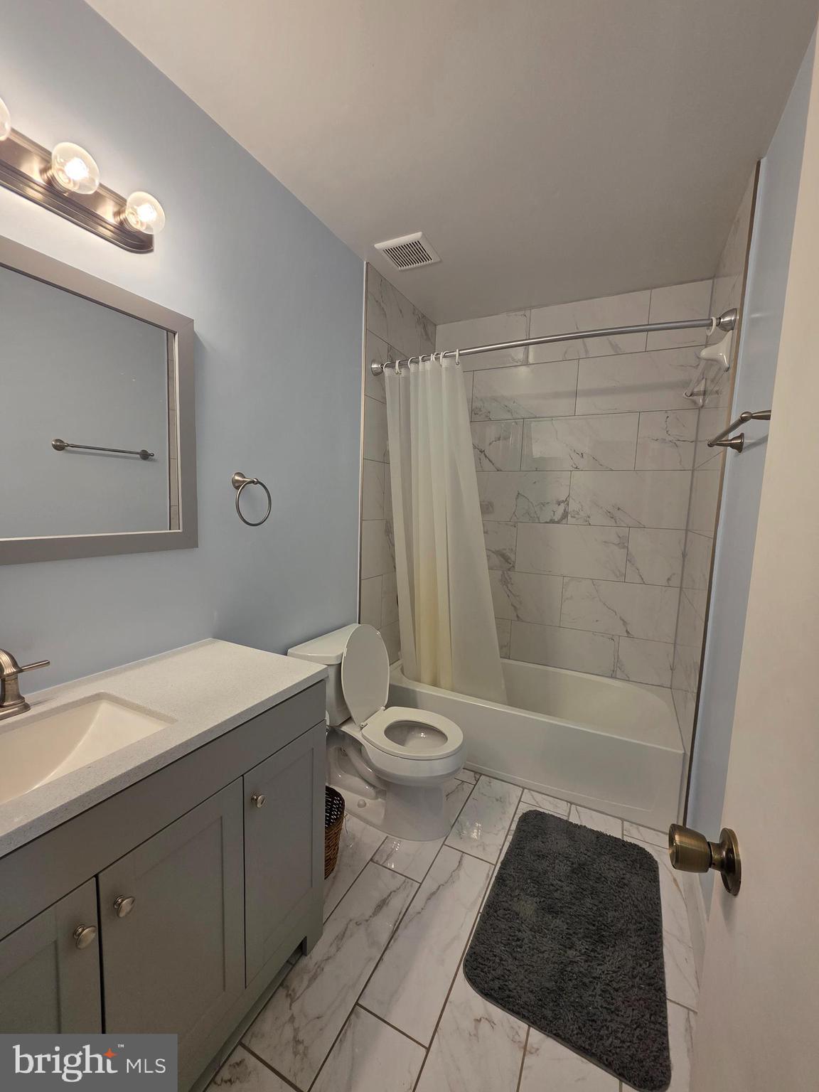 10 Casey Court Baltimore, MD 21228 - Photo 21 of 28 a bathroom with a sink a toilet a mirror and shower