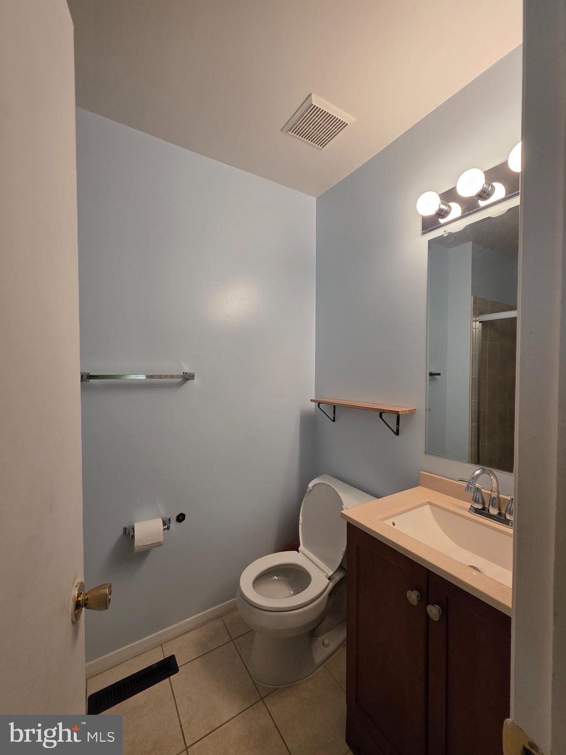 10 Casey Court Baltimore, MD 21228 - Photo 24 of 28 a bathroom with a granite countertop sink a toilet and a mirror