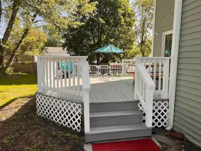 a view of stairs and patio with wooden fence
