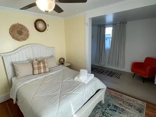 a bedroom with a bed and painting on the wall