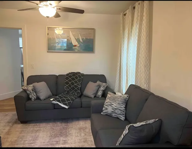 a living room with furniture and a window