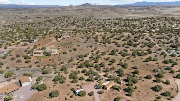 an aerial view of a house with a mountain