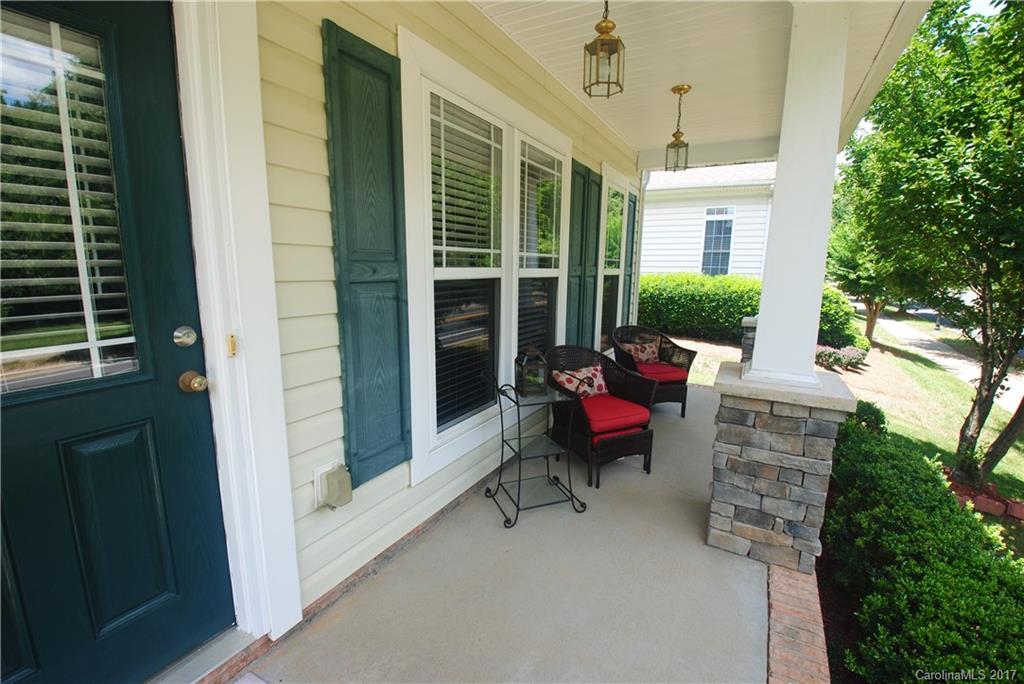 9834 Bailey Road Cornelius, NC 28031 - Photo 2 of 23 a balcony with furniture and a potted plant
