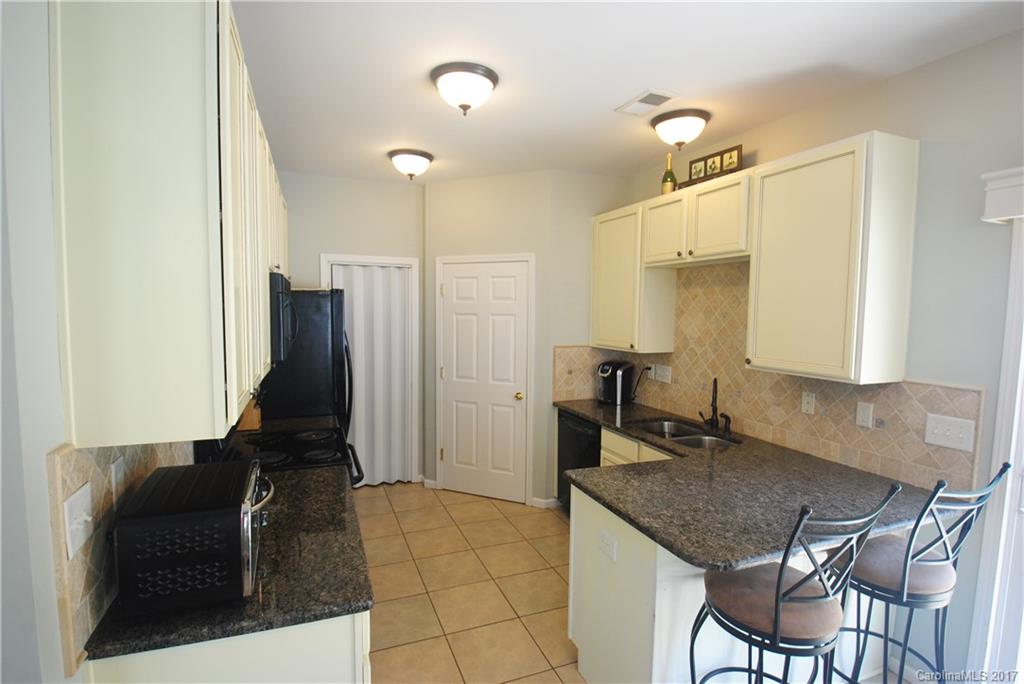 9834 Bailey Road Cornelius, NC 28031 - Photo 11 of 23 a kitchen with a table chairs and refrigerator
