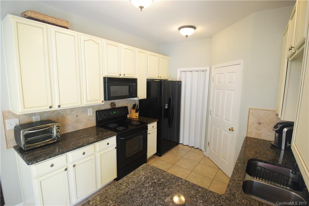 9834 Bailey Road Cornelius, NC 28031 - Photo 12 of 23 a kitchen with granite countertop a refrigerator stove and sink