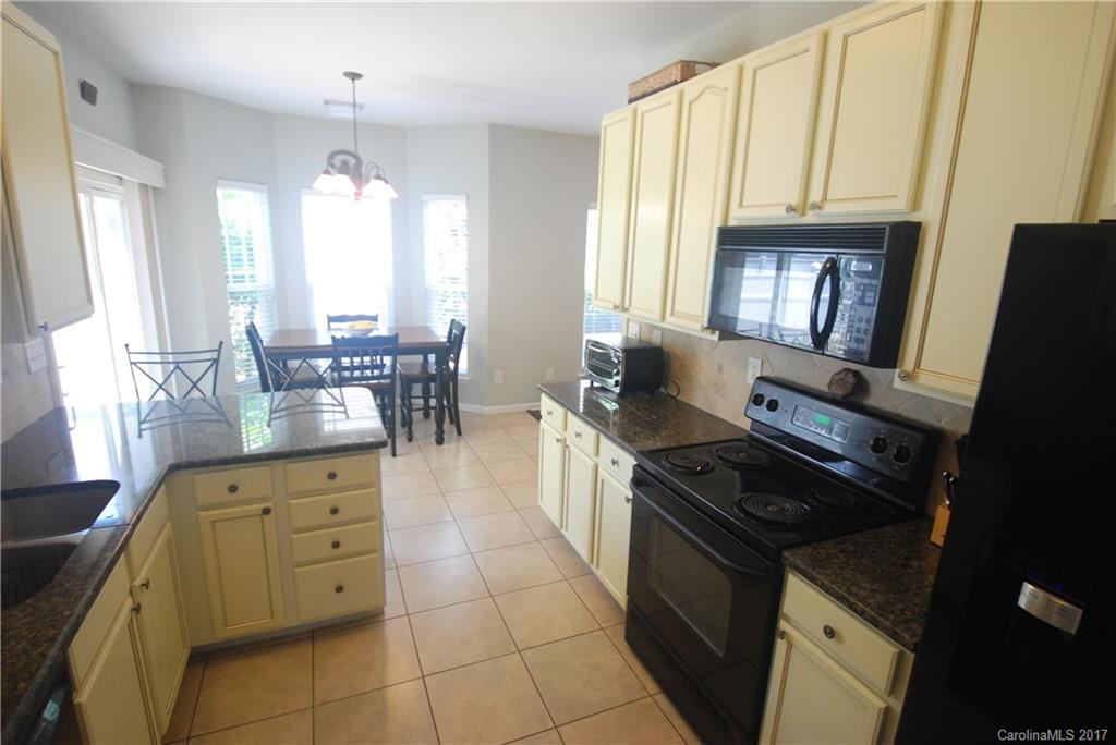 9834 Bailey Road Cornelius, NC 28031 - Photo 13 of 23 a kitchen with stainless steel appliances a stove a sink a counter space and cabinets