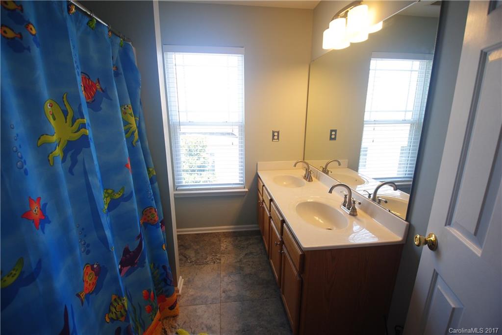 9834 Bailey Road Cornelius, NC 28031 - Photo 20 of 23 a bathroom with a sink and a mirror