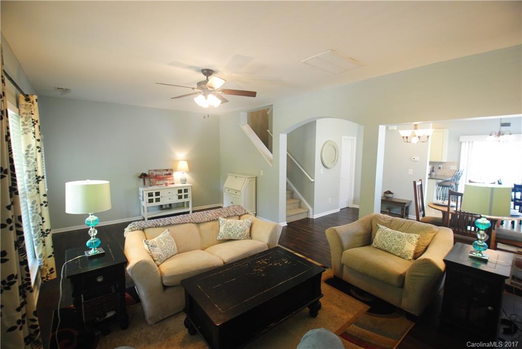 9834 Bailey Road Cornelius, NC 28031 - Photo 4 of 23 a living room with furniture a lamp and a ceiling fan