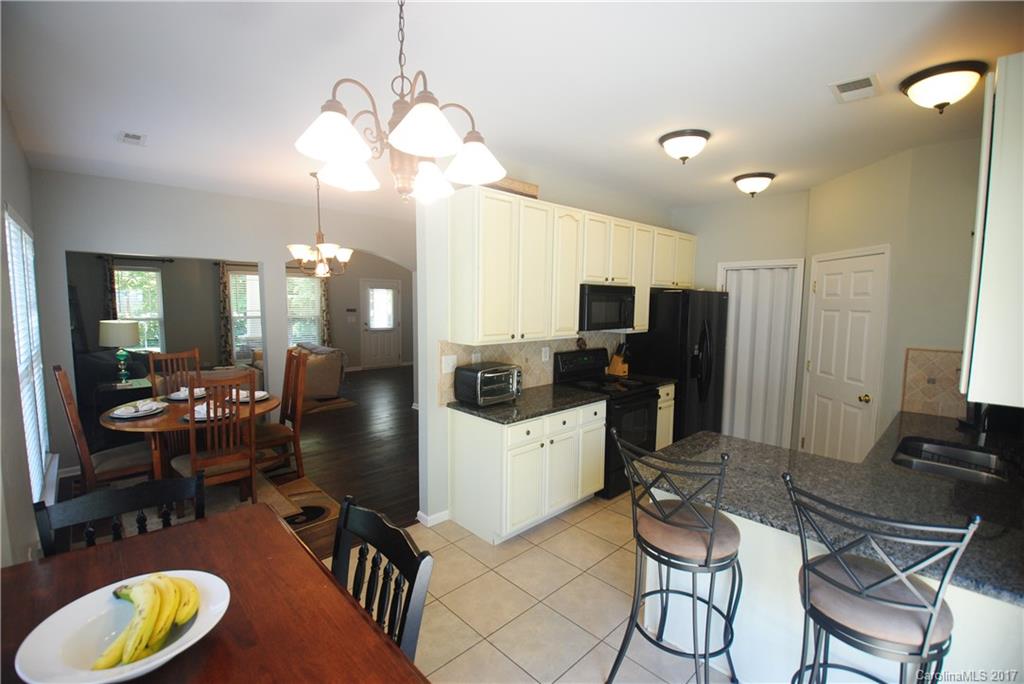 9834 Bailey Road Cornelius, NC 28031 - Photo 10 of 23 a kitchen that has a table chairs and refrigerator