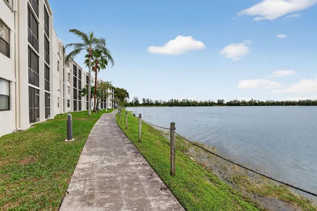 an aerial view of lake and residential houses with outdoor space