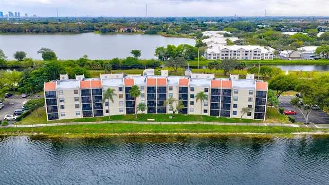 an aerial view of lake and houses with outdoor space