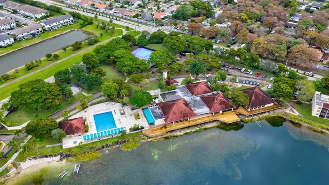 an aerial view of lake and residential houses with outdoor space