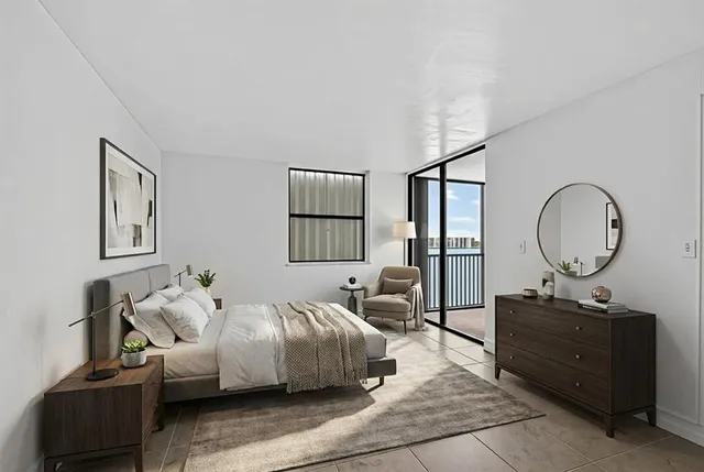 a bedroom with a bed window and couch