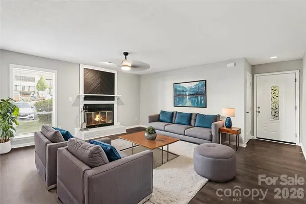 a living room with furniture and a fireplace