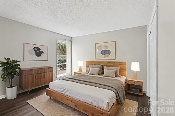 a bedroom with a large bed and a potted plant