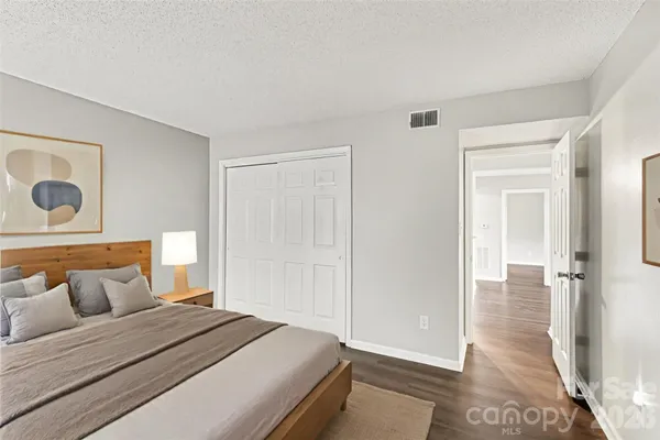 a bedroom with a bed and a mirror