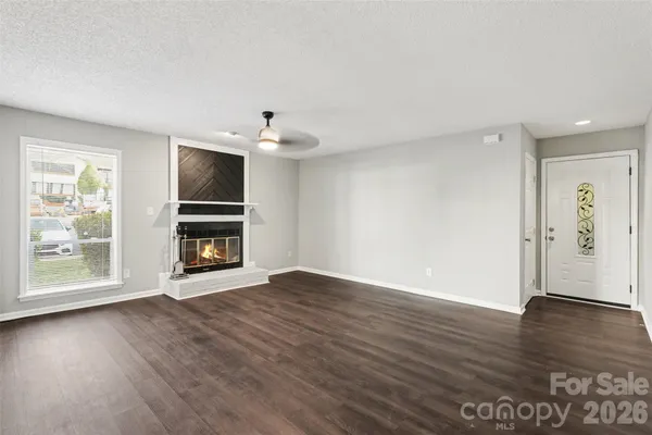 an empty room with wooden floor and window