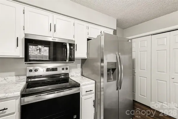 a kitchen with stainless steel appliances a refrigerator stove and microwave