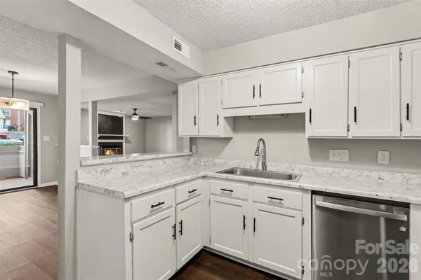 a kitchen with white cabinets and a sink