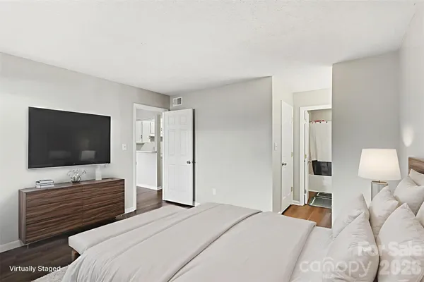 a bedroom with a bed and a flat screen tv