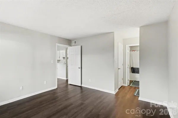 a big room with wooden floor and windows