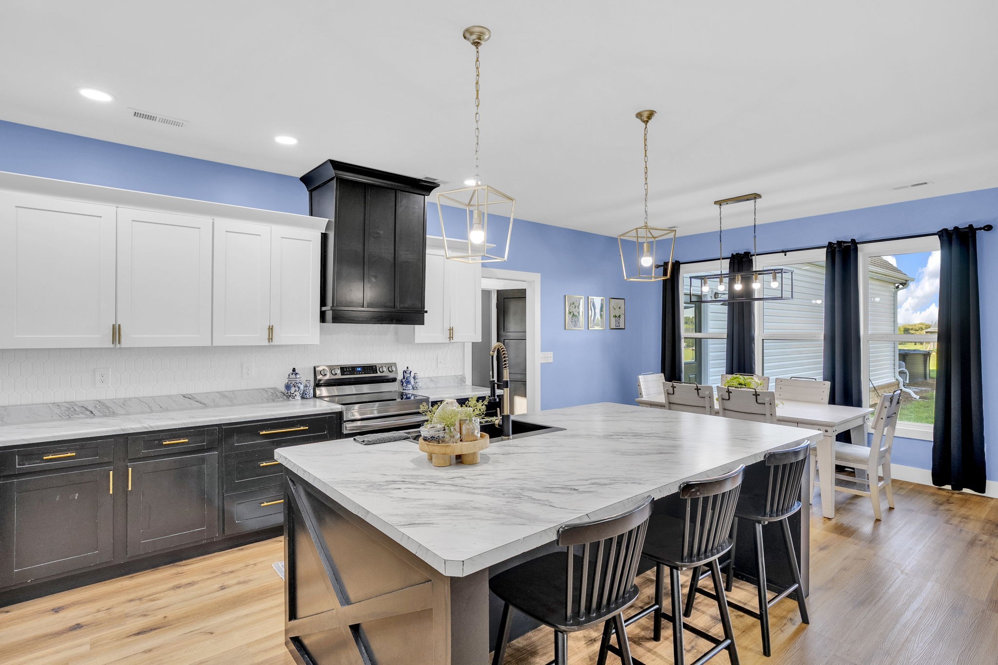426 Maple Bend Road Winchester, TN 37398 - Photo 17 of 73 a kitchen with stainless steel appliances granite countertop a kitchen island hardwood floor sink stove dining table and chairs