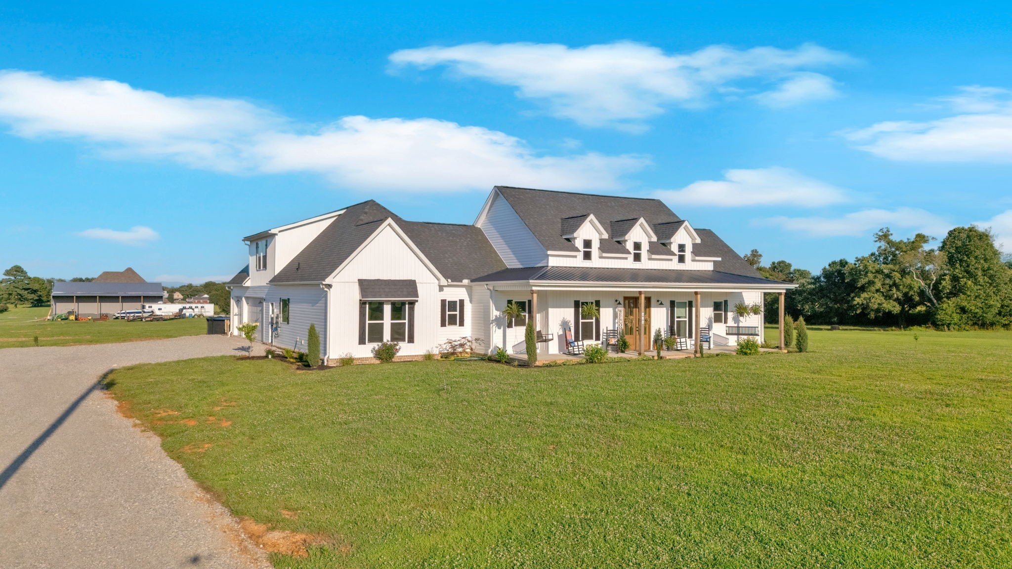 426 Maple Bend Road Winchester, TN 37398 - Photo 2 of 73 a view of a white house with a big yard and large trees