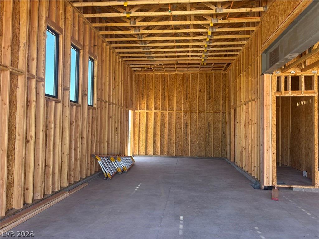 628 Hull Street Henderson, NV 89015 - Photo 5 of 9 A glimpse into a future home, this spacious garage boasts a concrete floor and robust wooden framing.